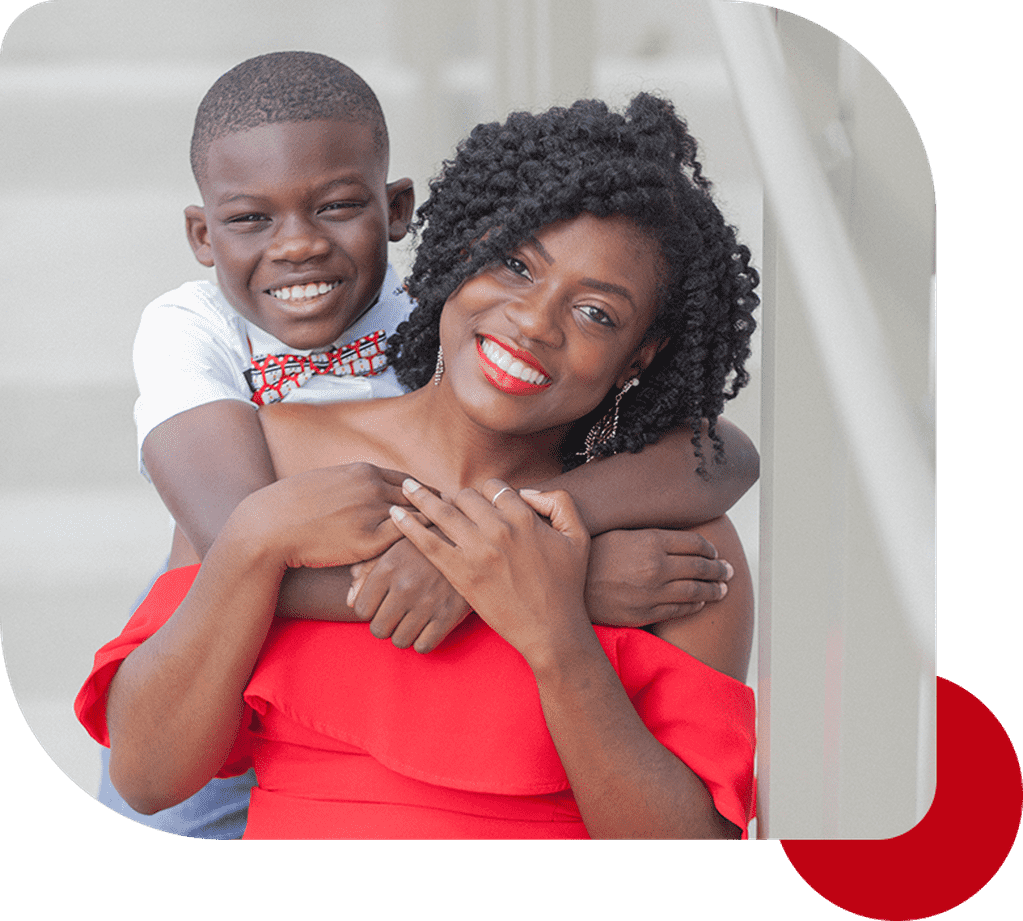 A woman and boy are smiling for the camera.