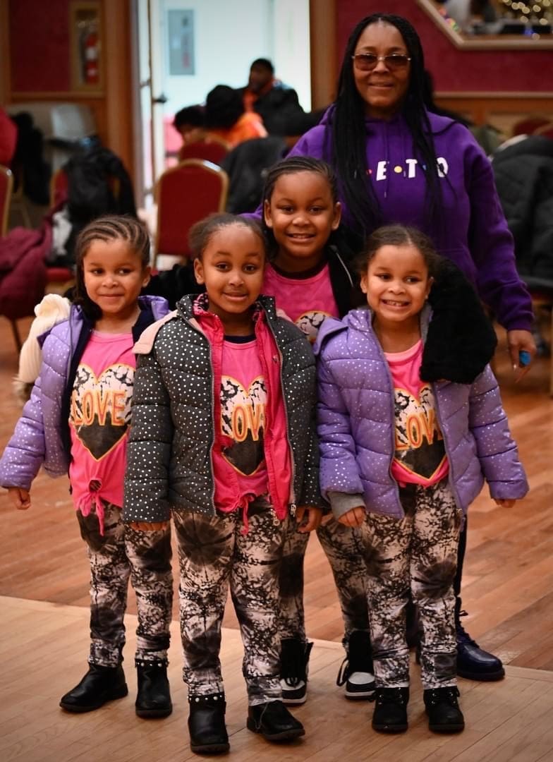 A group of young girls standing next to each other.