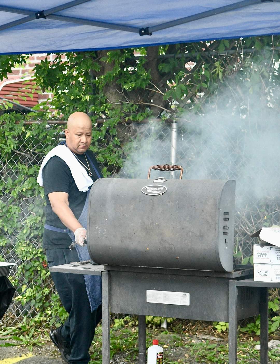 A man cooking on an outdoor grill.