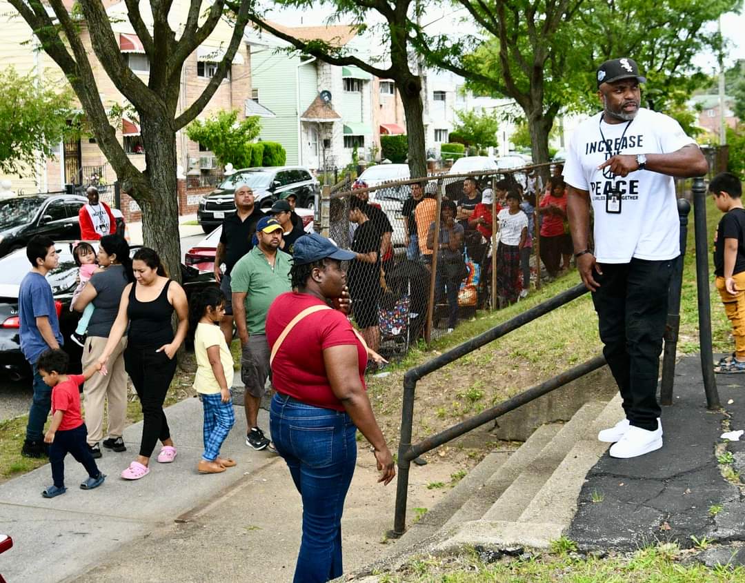 A group of people standing on steps near trees.