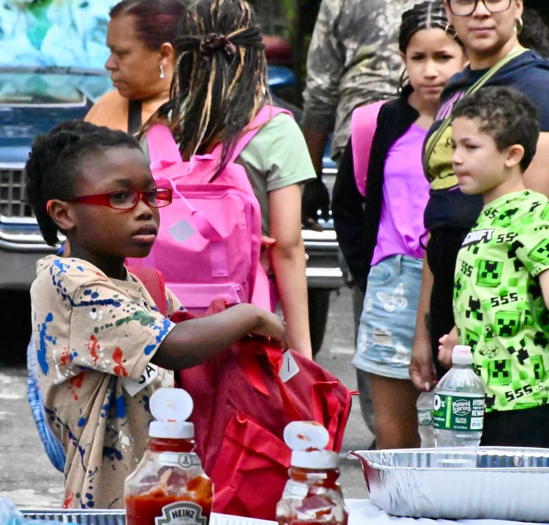 A group of children standing around a table.