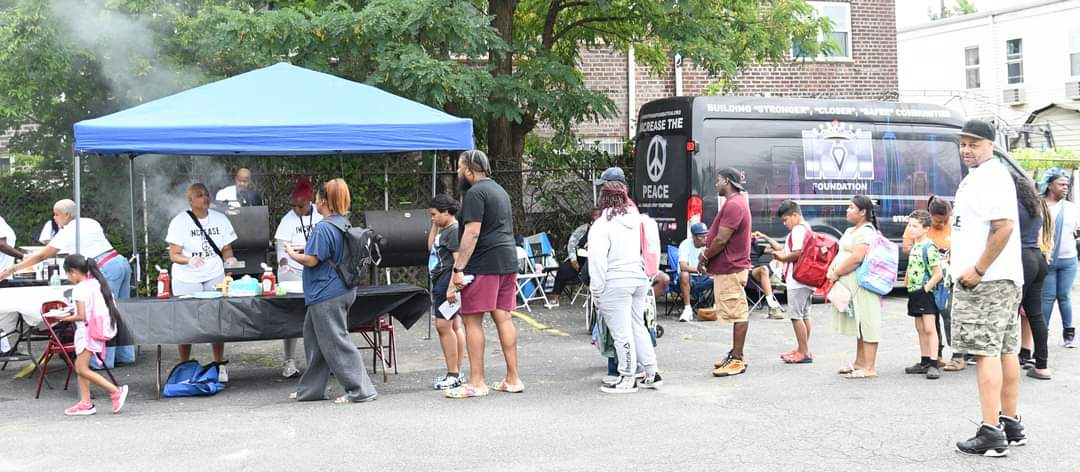 A group of people standing around an outdoor event.