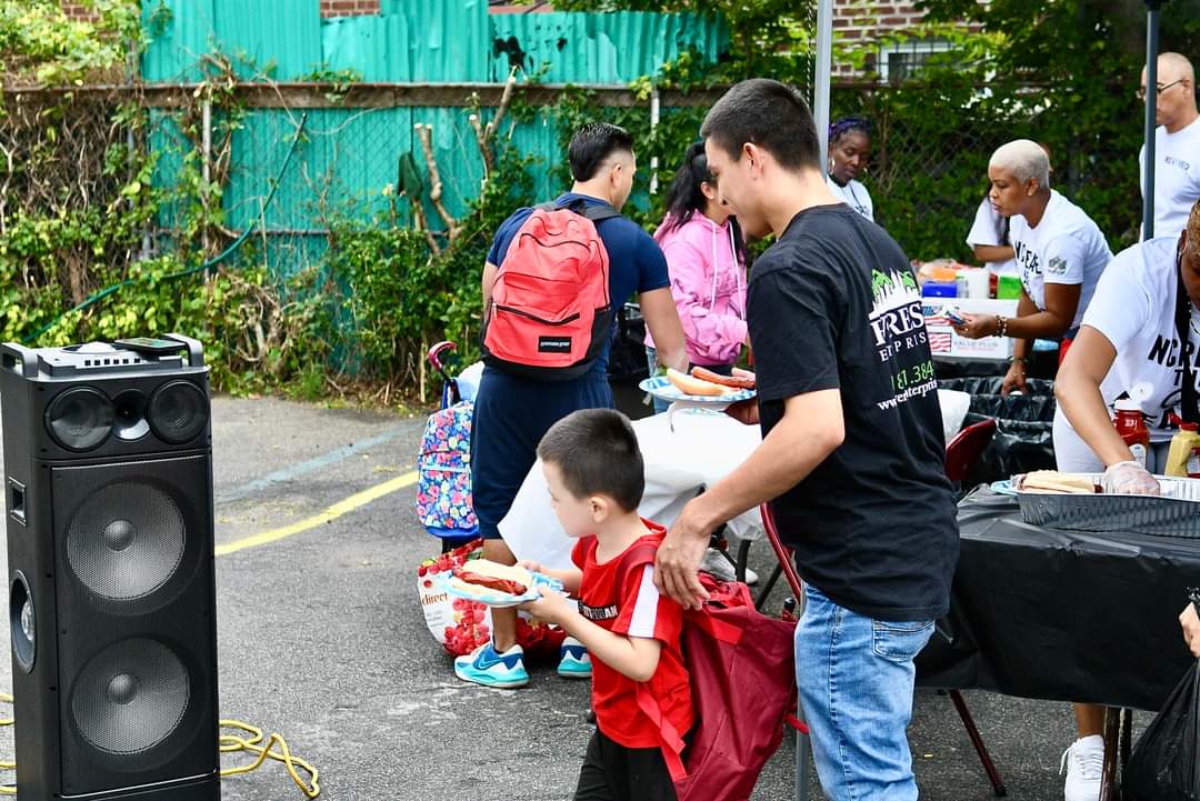 A man and boy with backpacks on the street.