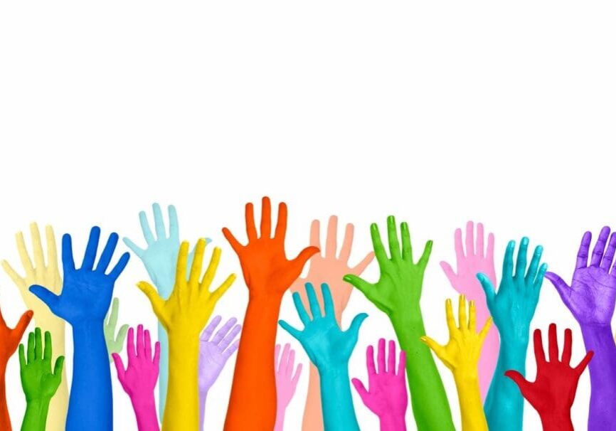 A group of colorful hands reaching up into the air.