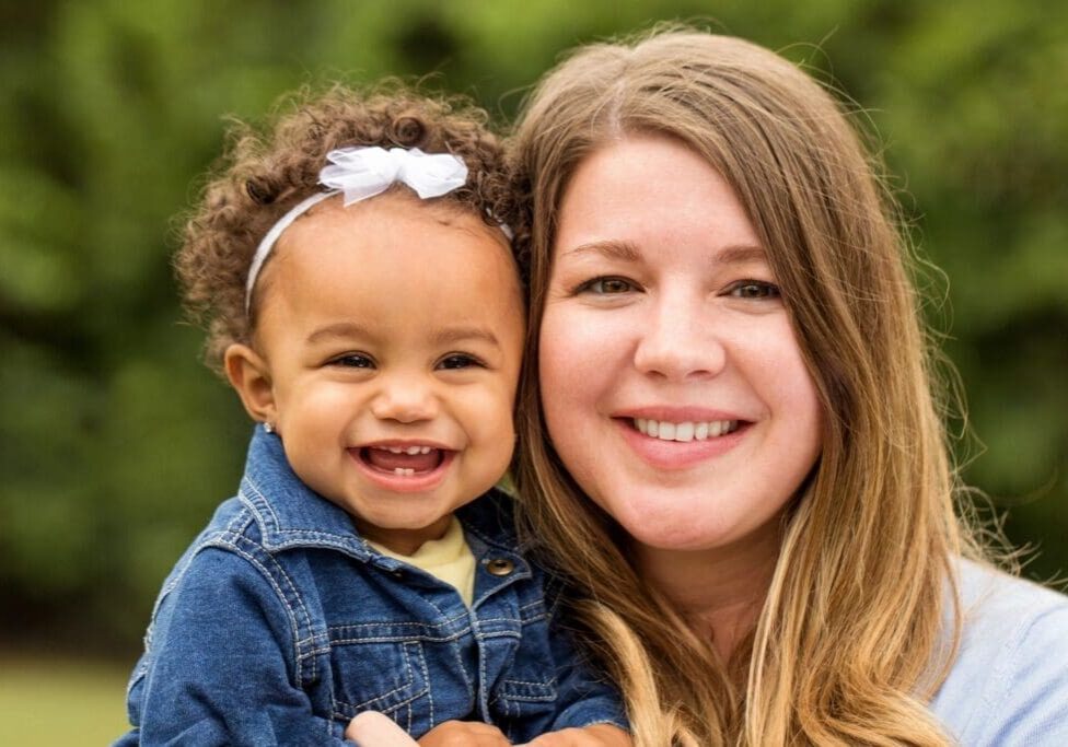 A woman holding a child in her arms.